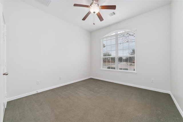 empty room featuring ceiling fan, dark colored carpet, visible vents, and baseboards