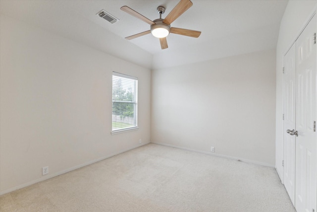 unfurnished bedroom featuring light carpet, baseboards, visible vents, ceiling fan, and a closet