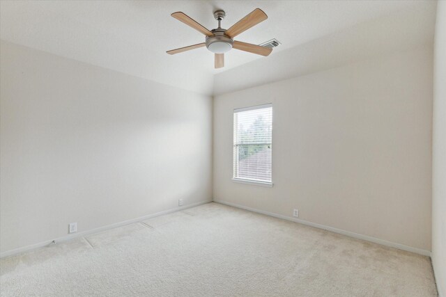 unfurnished room with visible vents, baseboards, a ceiling fan, and light colored carpet