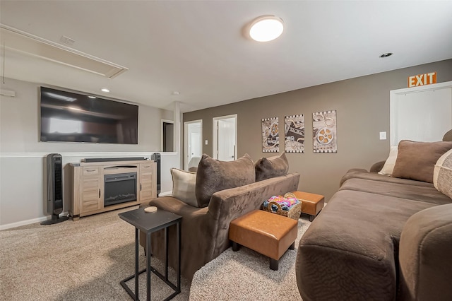 living room with light carpet, a fireplace, attic access, and baseboards