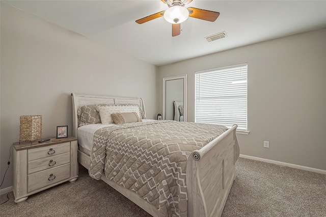 carpeted bedroom with a ceiling fan, visible vents, and baseboards