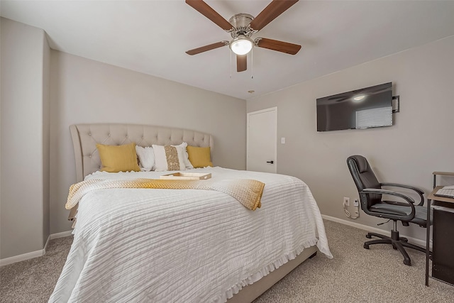 carpeted bedroom with a ceiling fan and baseboards