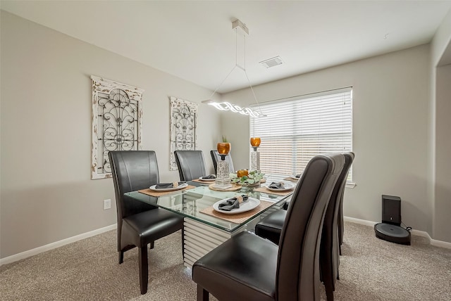 dining space featuring carpet, visible vents, and baseboards