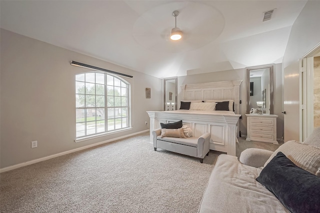 carpeted bedroom featuring baseboards, visible vents, ceiling fan, ensuite bathroom, and vaulted ceiling