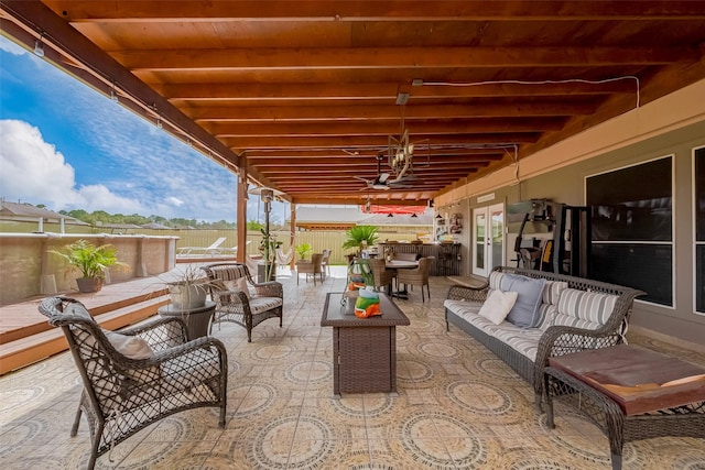 view of patio with french doors, outdoor dining space, fence, and an outdoor living space