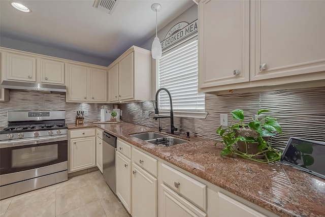 kitchen with stainless steel appliances, visible vents, light tile patterned flooring, a sink, and under cabinet range hood