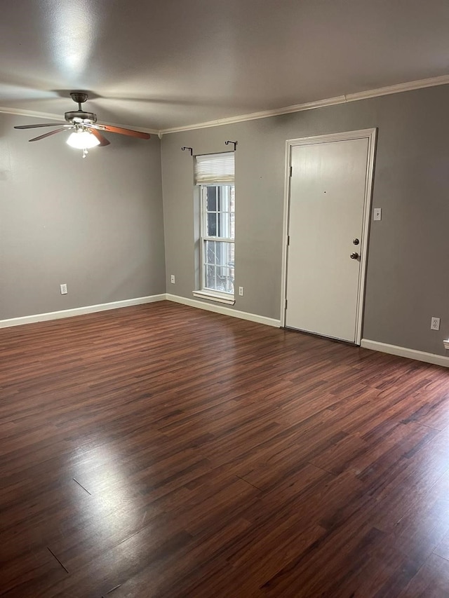 unfurnished room featuring dark wood-style flooring and crown molding