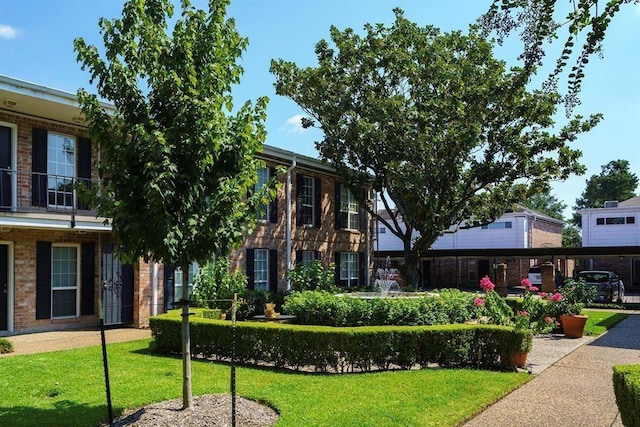 view of front of property with a front yard and brick siding