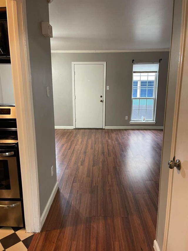 entryway featuring crown molding, baseboards, and wood finished floors