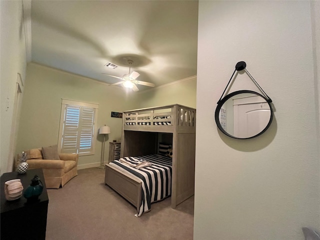 carpeted bedroom with visible vents, a ceiling fan, and ornamental molding