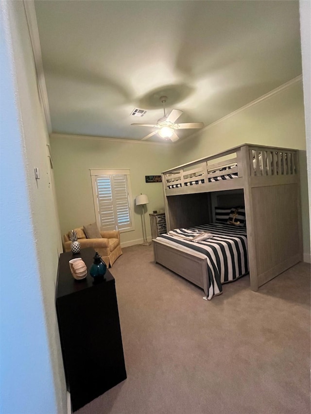 carpeted bedroom with ceiling fan, ornamental molding, visible vents, and baseboards