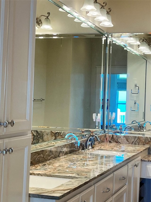 bathroom featuring a sink and double vanity