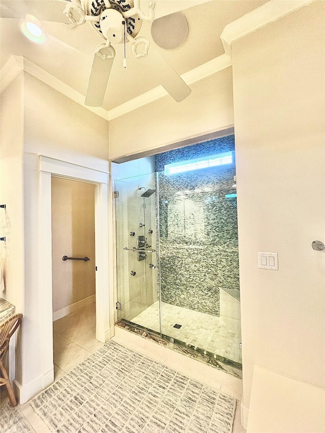 bathroom with ceiling fan, tile patterned flooring, a shower stall, and baseboards