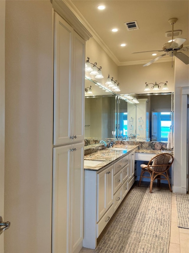 bathroom featuring double vanity, visible vents, ceiling fan, ornamental molding, and tile patterned floors