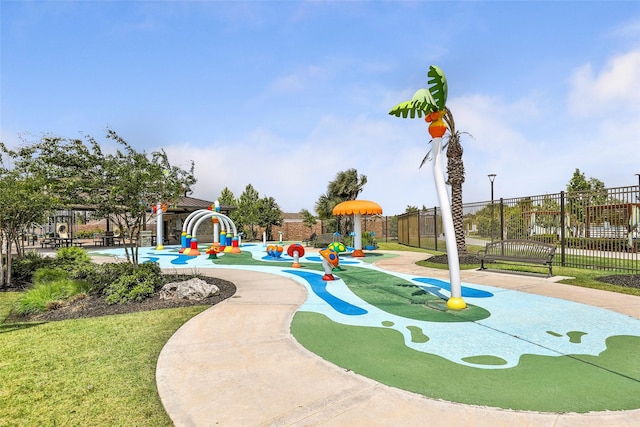 view of property's community featuring playground community and fence