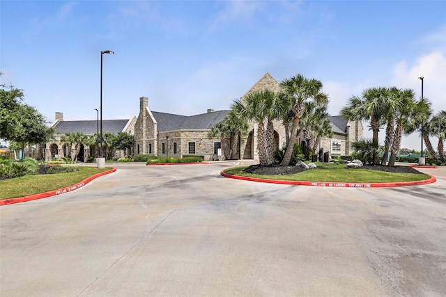 view of building exterior featuring curved driveway