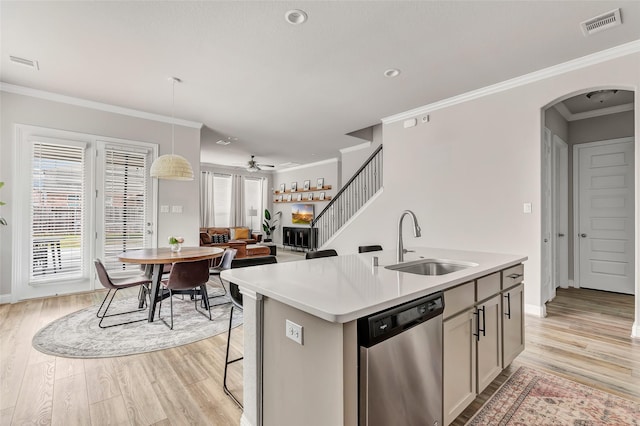 kitchen featuring arched walkways, a wealth of natural light, visible vents, stainless steel dishwasher, and a sink