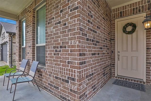 doorway to property with brick siding