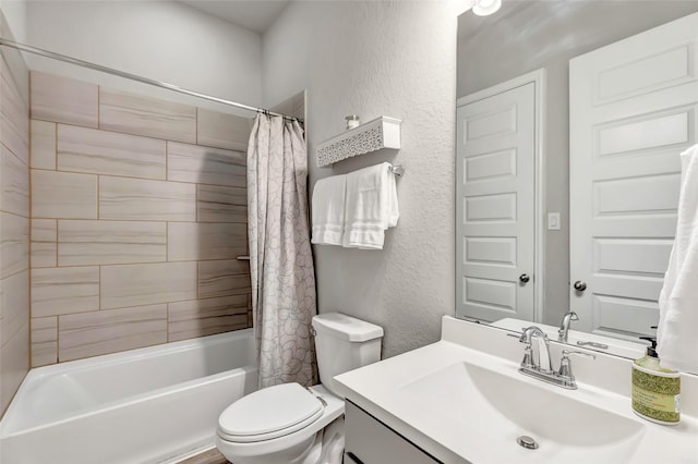 bathroom featuring toilet, vanity, shower / bath combination with curtain, and a textured wall