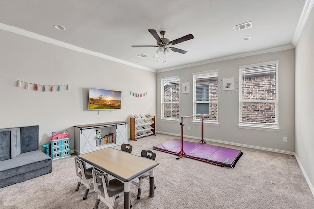 recreation room featuring carpet, visible vents, baseboards, and ornamental molding