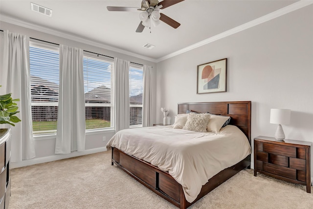 bedroom featuring light colored carpet, crown molding, visible vents, and baseboards