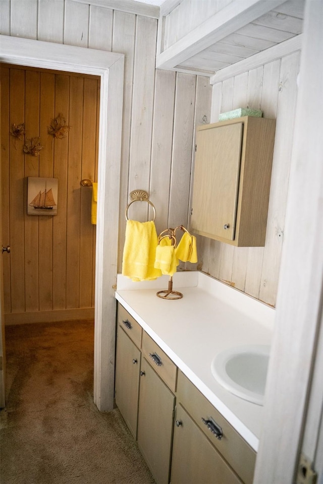 bathroom featuring vanity and wooden walls