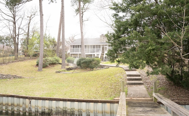 view of yard with a sunroom and stairway