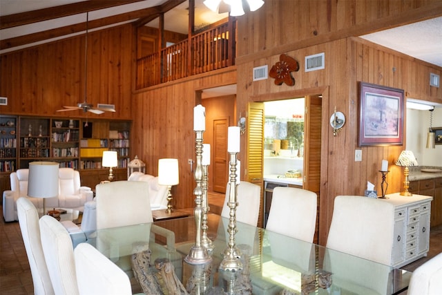 dining area featuring visible vents, wood walls, and ceiling fan