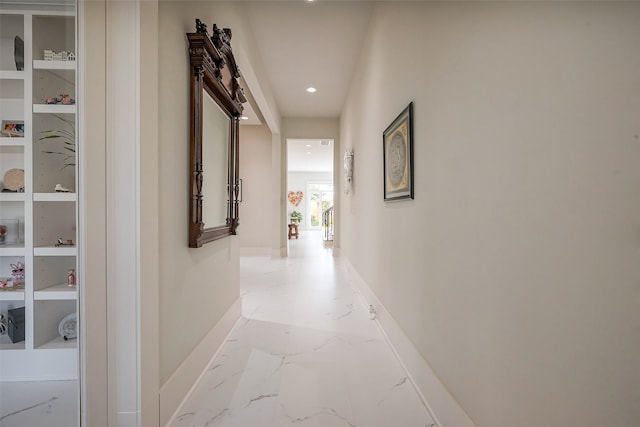 hall featuring marble finish floor, baseboards, and recessed lighting