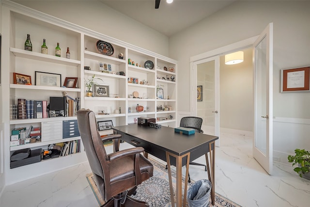 office space featuring a ceiling fan, marble finish floor, and baseboards