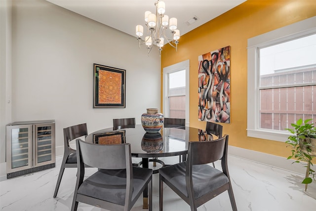 2217 W Main St, Houston, TX 77098 - dining area with wine cooler, marble tiled floors, and a chandelier