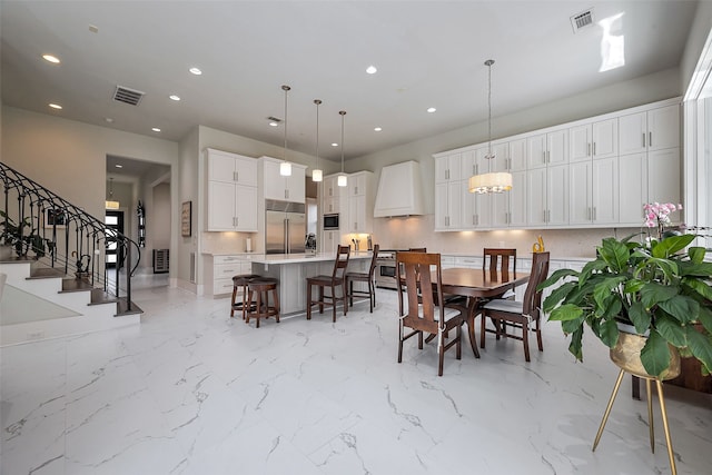 dining room with stairway, visible vents, and recessed lighting