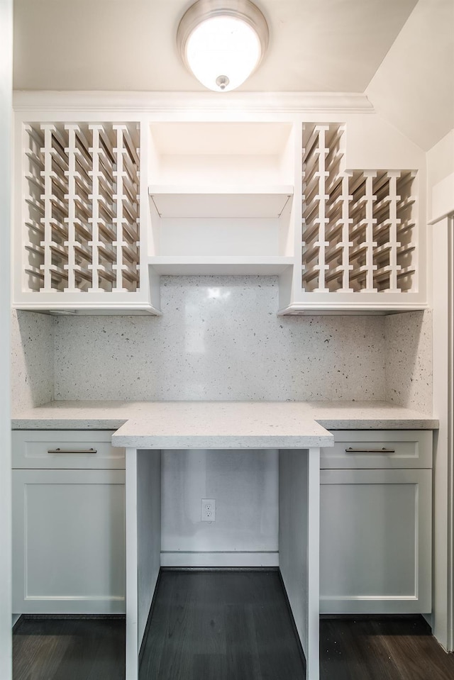 kitchen featuring open shelves, dark wood finished floors, light stone countertops, and decorative backsplash