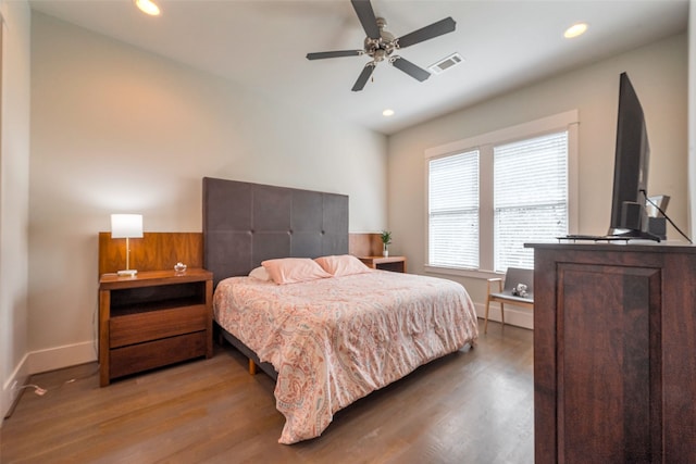 bedroom featuring recessed lighting, visible vents, baseboards, and wood finished floors