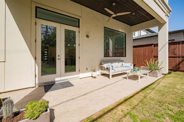 view of patio / terrace featuring a ceiling fan, french doors, fence, and an outdoor living space