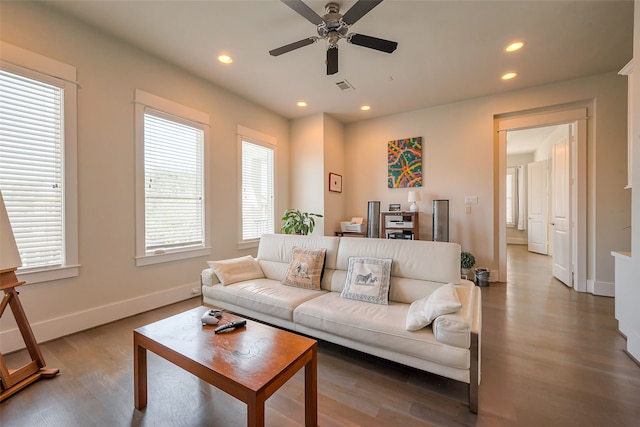 living area featuring baseboards, wood finished floors, visible vents, and recessed lighting