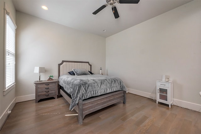 bedroom with recessed lighting, multiple windows, light wood-style flooring, and baseboards