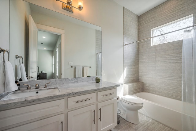 full bathroom featuring shower / bathtub combination, vanity, and toilet