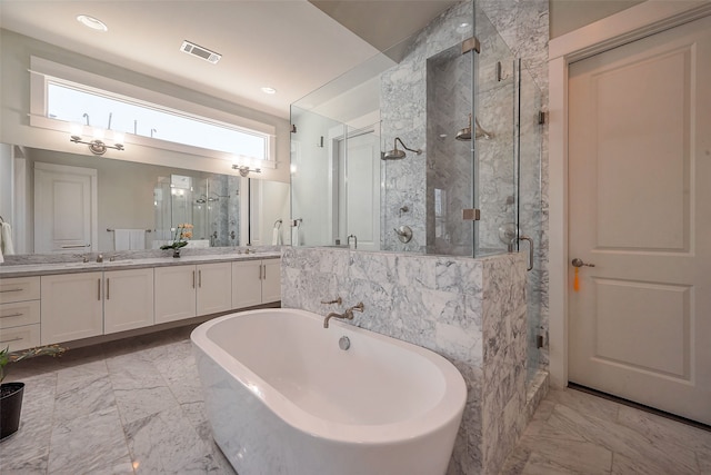 full bathroom with marble finish floor, a stall shower, vanity, and visible vents