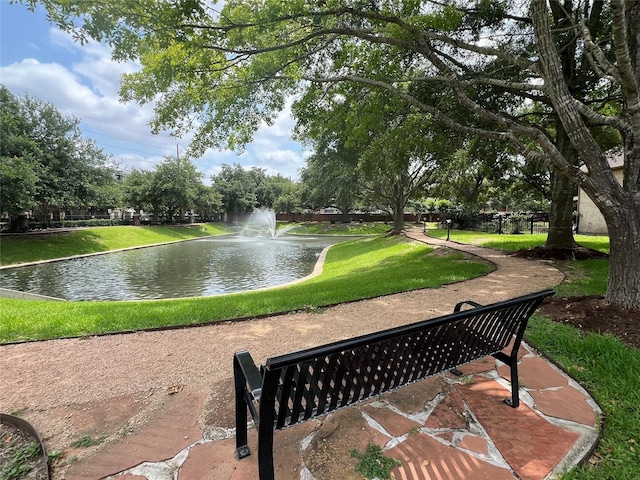 view of home's community featuring a yard and a water view