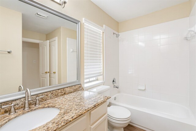 full bathroom featuring toilet, visible vents,  shower combination, and vanity