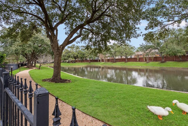 view of yard with a water view and fence