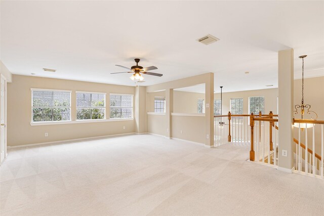 unfurnished room featuring light carpet, visible vents, and baseboards