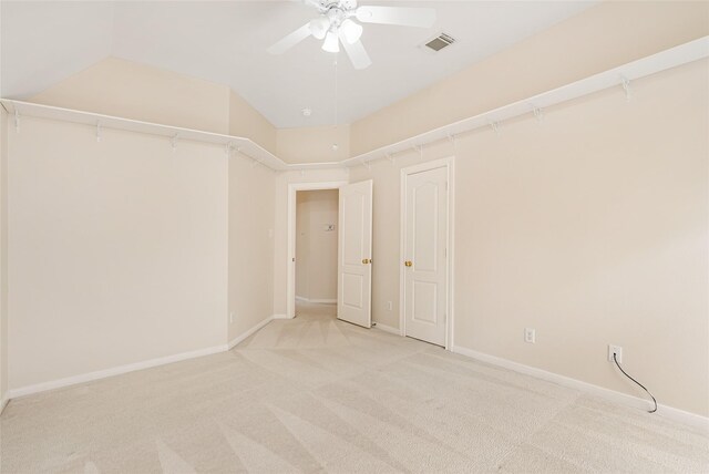 spare room with visible vents, ceiling fan, light carpet, and baseboards