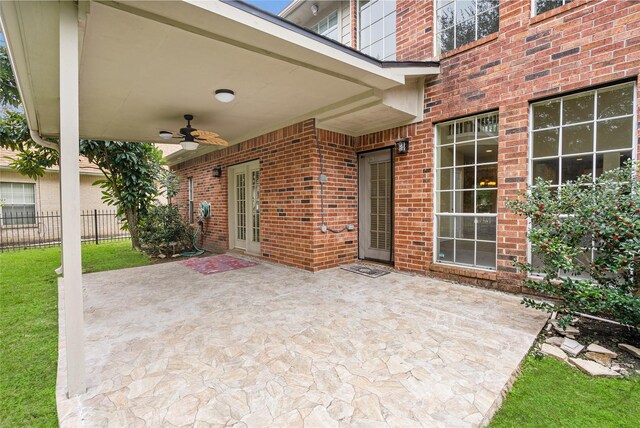 view of patio with ceiling fan and fence