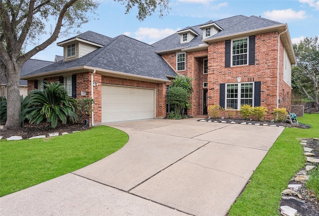 view of front facade with an attached garage, brick siding, driveway, roof with shingles, and a front lawn