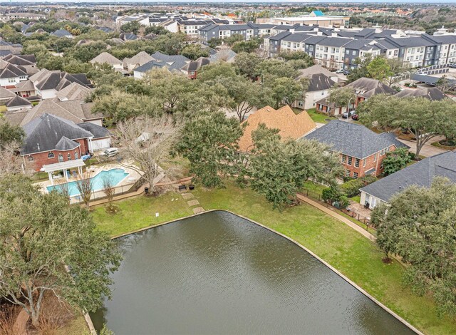 birds eye view of property with a water view and a residential view