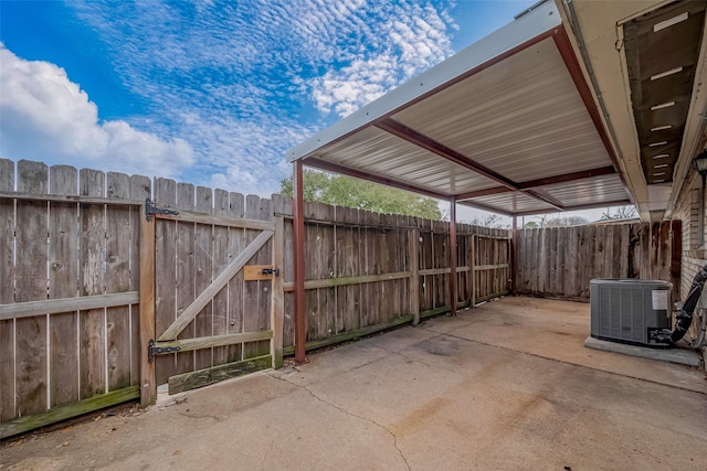 view of patio / terrace featuring a gate, fence, and central AC unit