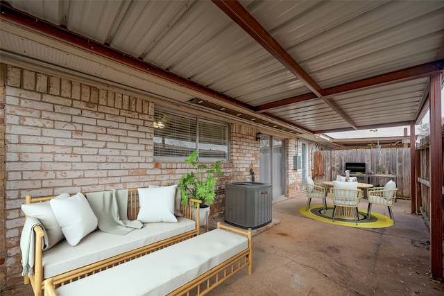 view of patio with outdoor dining area, fence, and central AC unit