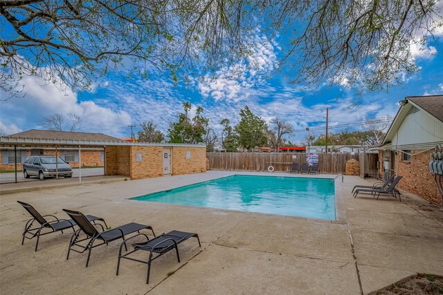 pool featuring a patio area and fence